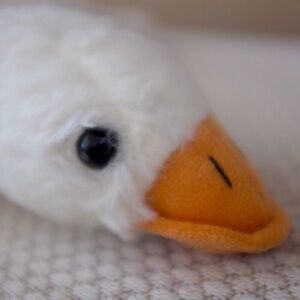 COPY - White goose plush stuffed animal relaxing resting